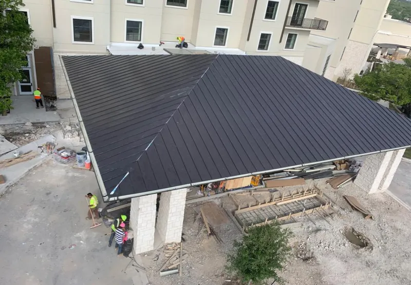 Metal roofing installation team working on a commercial building in Fruit Cove
