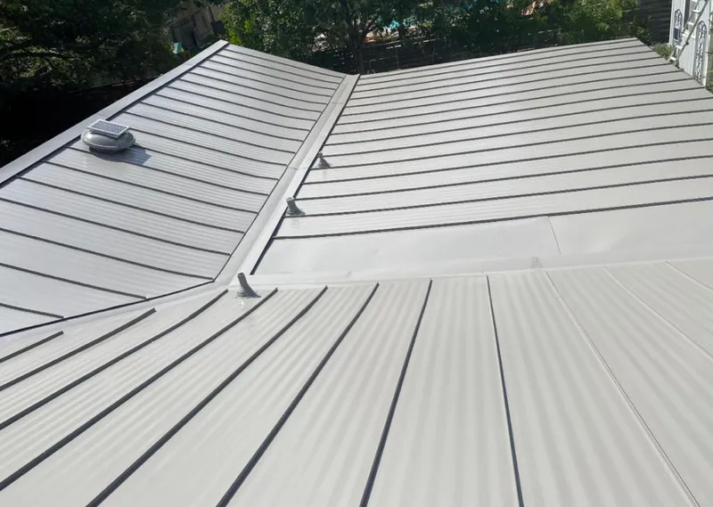 Solar attic fan installed on a metal roof for Roof Ventilation in Fruit Cove